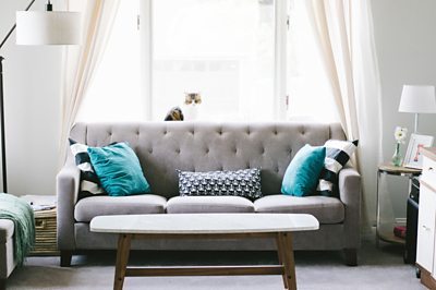 A sofa in a bright and airy living room.