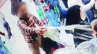 Man pours yoghurt over a woman in a shop