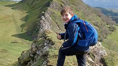 An eight-year-old climbing a hill