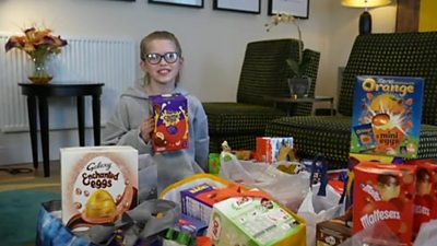 Clarissa with some of the Easter eggs that have been donated