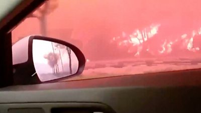 View from a car door at a wildfire burning