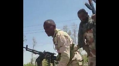 Soldiers raising guns to celebrate