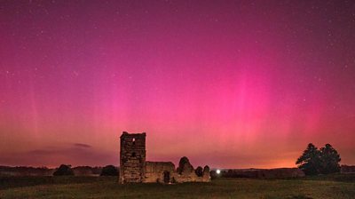 Knowlton church with northern lights in the sky