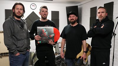 Post-metal band Motions pose for a photograph with their debut vinyl record