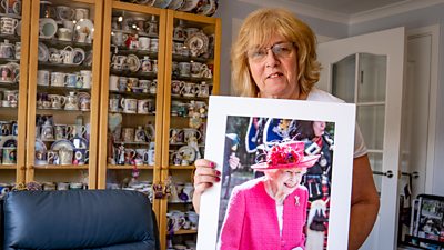 Royal enthusiast Sheila Clark stands with a portrait of Queen Elizabeth II