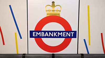 Shot of Embankment Station sign with crown on top