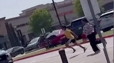 People running through a shopping mall car park