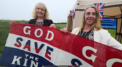 Jane Glover and Kirrie Jenkins holding a God save the King banner