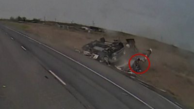 Man appears from wreckage of a flipped RV on side of highway