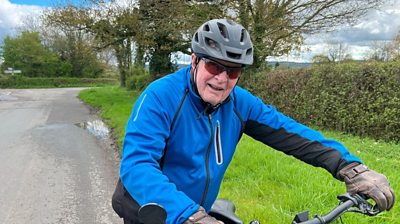 88-year-old Thomas smiling on his bike