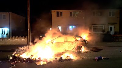 Car burning on street