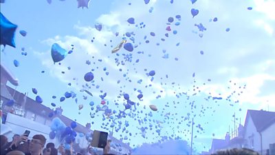 Balloons released in the air at a vigil in Ely