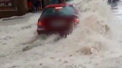 Car trying to cross floodwaters in Spain