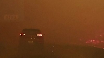 Car drives through a wildfire in Canada