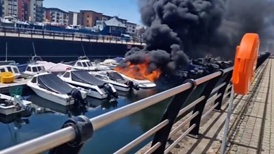 boat in a marina on fire