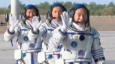 Three chinese astronauts wave to the camera