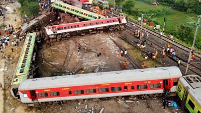 Damaged trains beside a track in India, aerial photograph