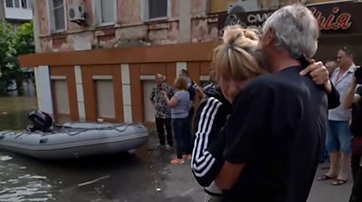 Woman is hugged in Kherson after evacuation from floods
