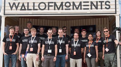 Group photo of the team at the Wall of Moments