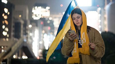 A Ukrainian woman checks her phone