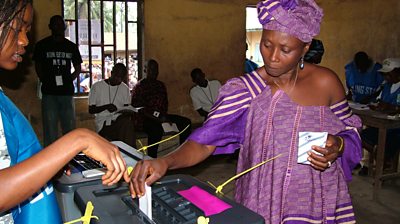 A woman in Sierra Leone casts her vote