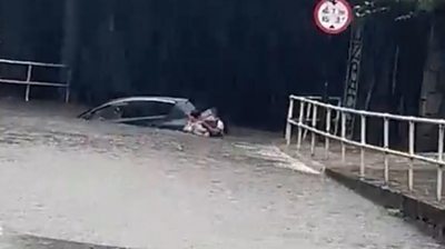 A man helping a woman after flooding