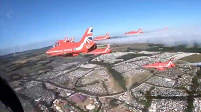 Red Arrows fly over Glastonbury site