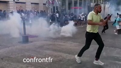 Person running from tear gas