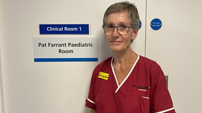 King's College Hospital sonographer Pat Farrant in front her door in the new ultrasound unit.
