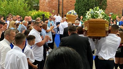 Coffins being carried