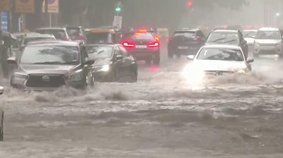 Cars driving through water