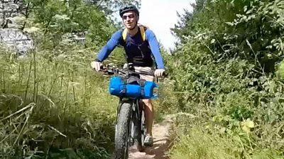 Jon Cuthill rides mountain bike down overgrown path