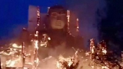 Fire surrounds a giant buddha statue in China's north-west Gansu province