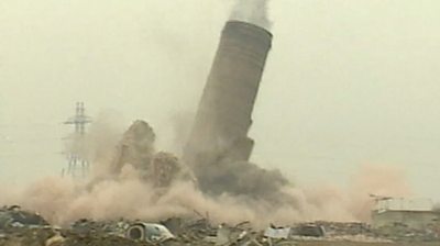 Archive video shows the moment a 200ft (61m) chimney is toppled by explosives to make way for homes.