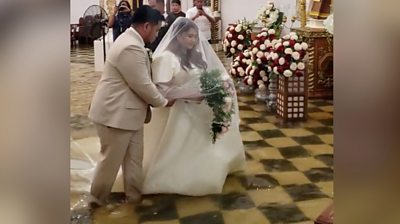 Bride and groom walk down flooded aisle
