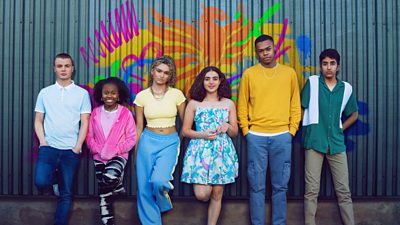 Billy, Leila, Summer, Rani, Darcy and Khaled stand in front a graffiti image of a phoenix