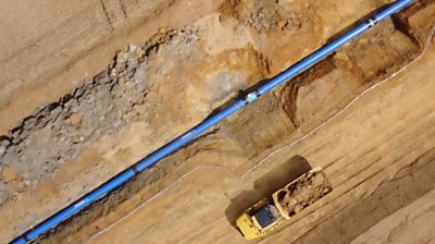 Aerial pictures show the £500m pipe being laid to move water from north to south in a region.