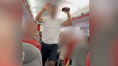 Watch: Man removed from plane after bomb alert