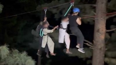 Zip line rescuers pull children to safety