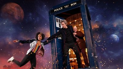 Peter Capaldi as The Doctor rescues his companion Bill as she dangles from the TARDIS in space