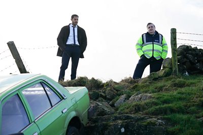Detective Colman Akande (DARYL McCORMACK), Aiden Massey (SIMON DELANEY) in The Woman in the Wall (Credit: BBC/Motive Pictures/Chris Barr)