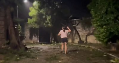Woman running during Typhoon Saolo
