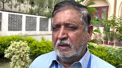 Muhammad Sharif standing in a garden