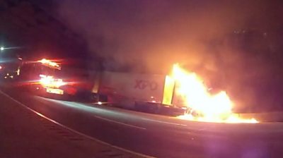 Burning lorry and a fire engine