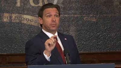 Ron DeSantis at a podium