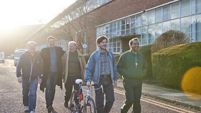 Mark Lewis Jones, Paul Rhys, Steffan Rhodri, Iwan Rheon walking on a residential street, Iwan in walking with the bike beside him
