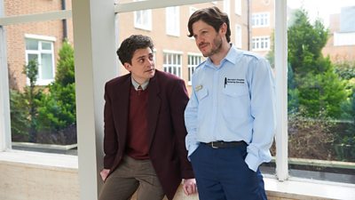 Aneurin Barnard and Iwan Rheon sitting on a windowsil