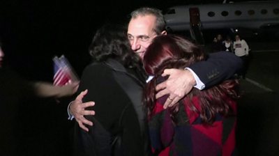 Man hugging two women