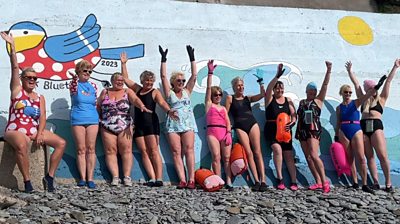 Manx Bluetits swimmers in front of the mural at Port Jack