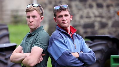 Jack and Liam standing in front of a tractor
